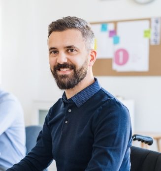 young-businessman-in-wheelchair-with-colleagues-EWTN4AC.jpg